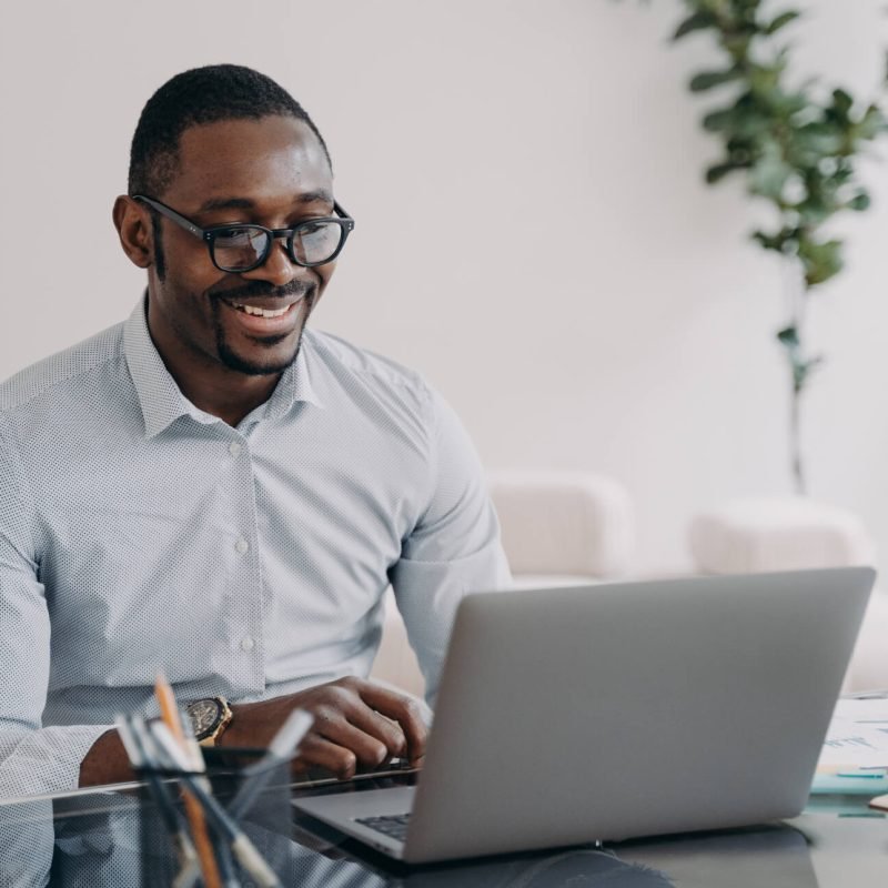 smiling-african-american-man-wearing-glasses-worki-CWQK3CT